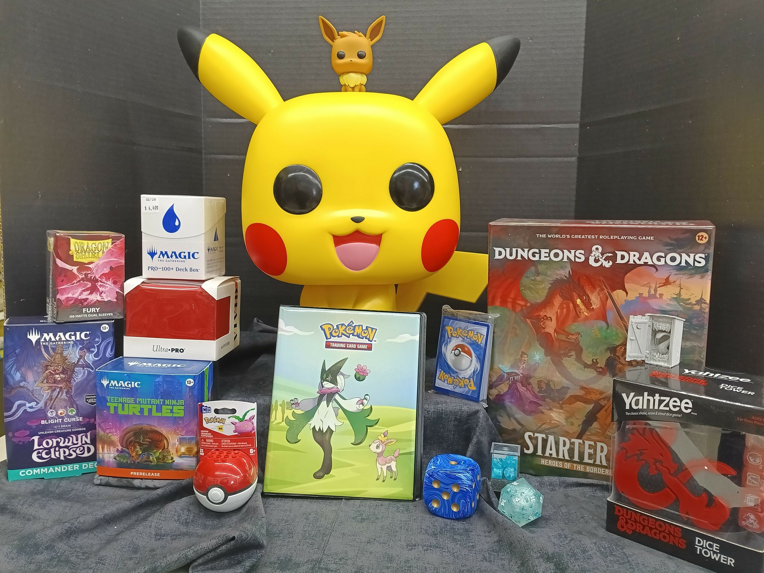 Collection of Pokémon, Dungeons & Dragons, and other gaming items with Pikachu figure in center.