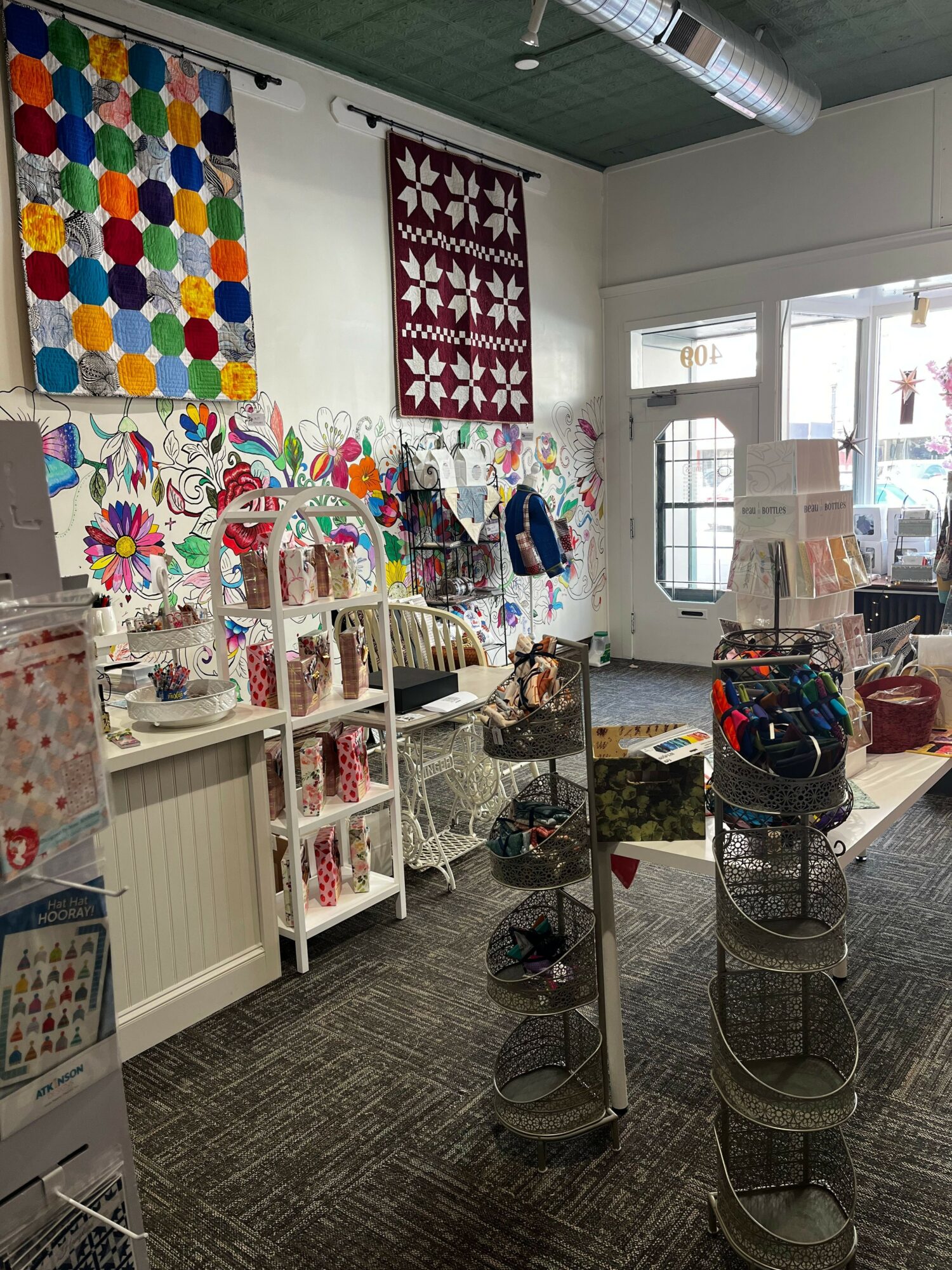 Indoor craft room with colorful decorations, tables, and shelves filled with art supplies and finished projects.