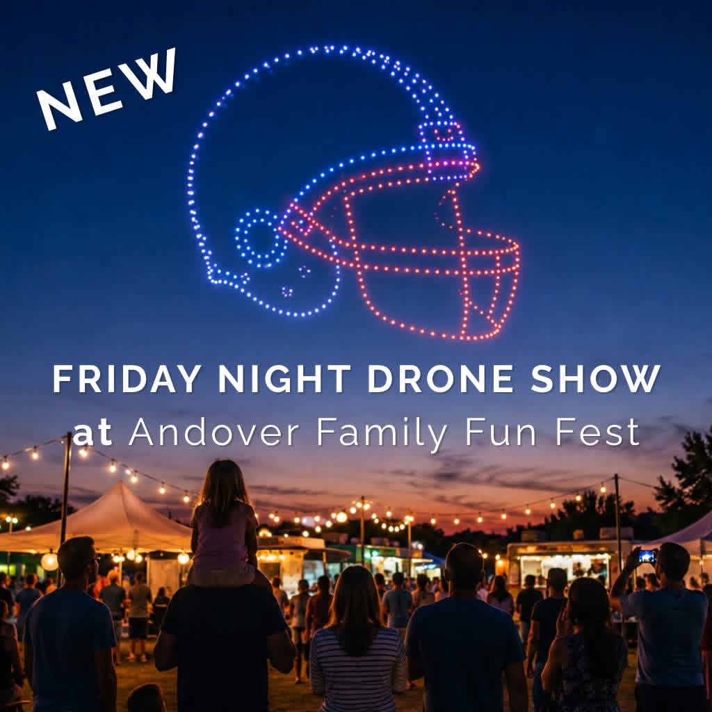 People gather outdoors at sunset for a drone show with a neon helmet outline and text about a Friday night event.