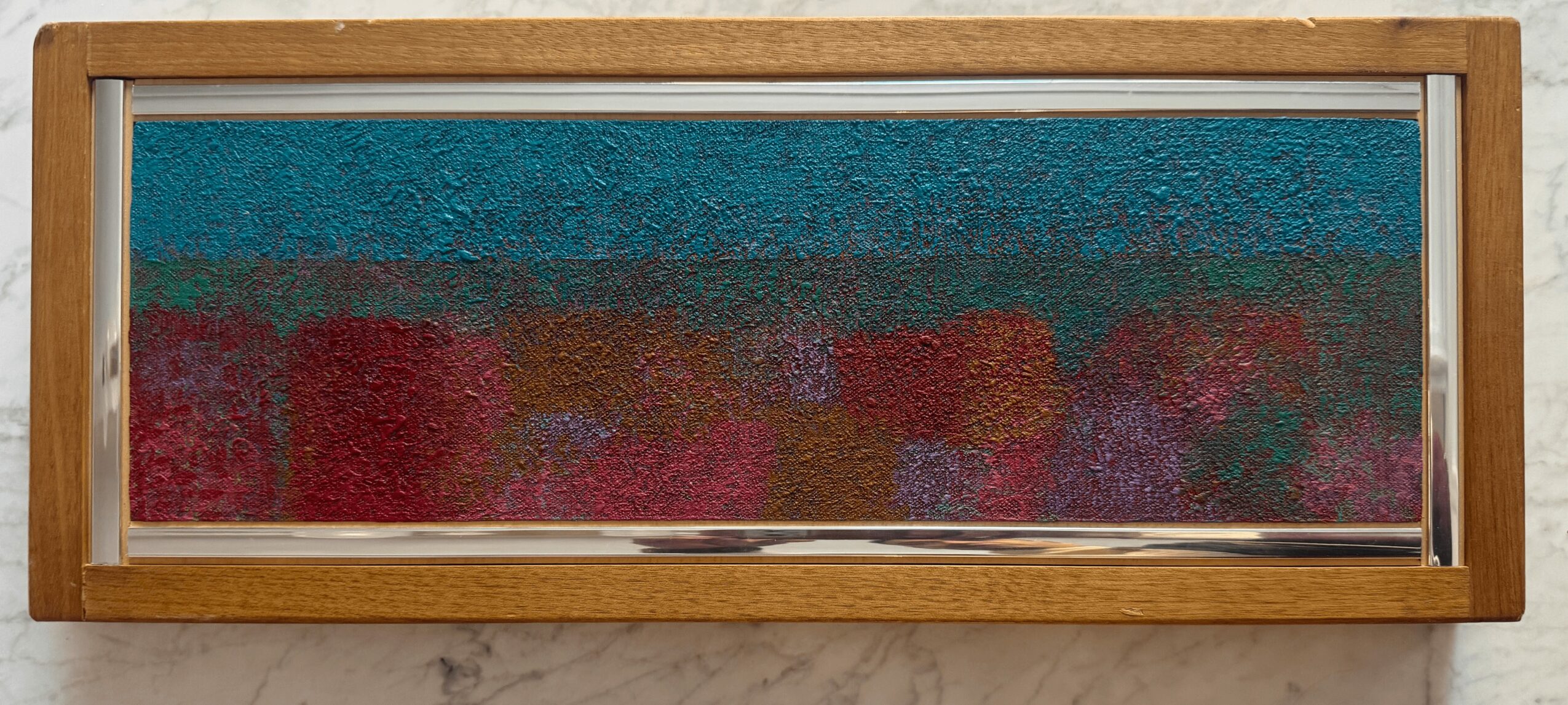 Horizontal abstract painting with textured blue, red, purple, and pink colors in a wooden frame.