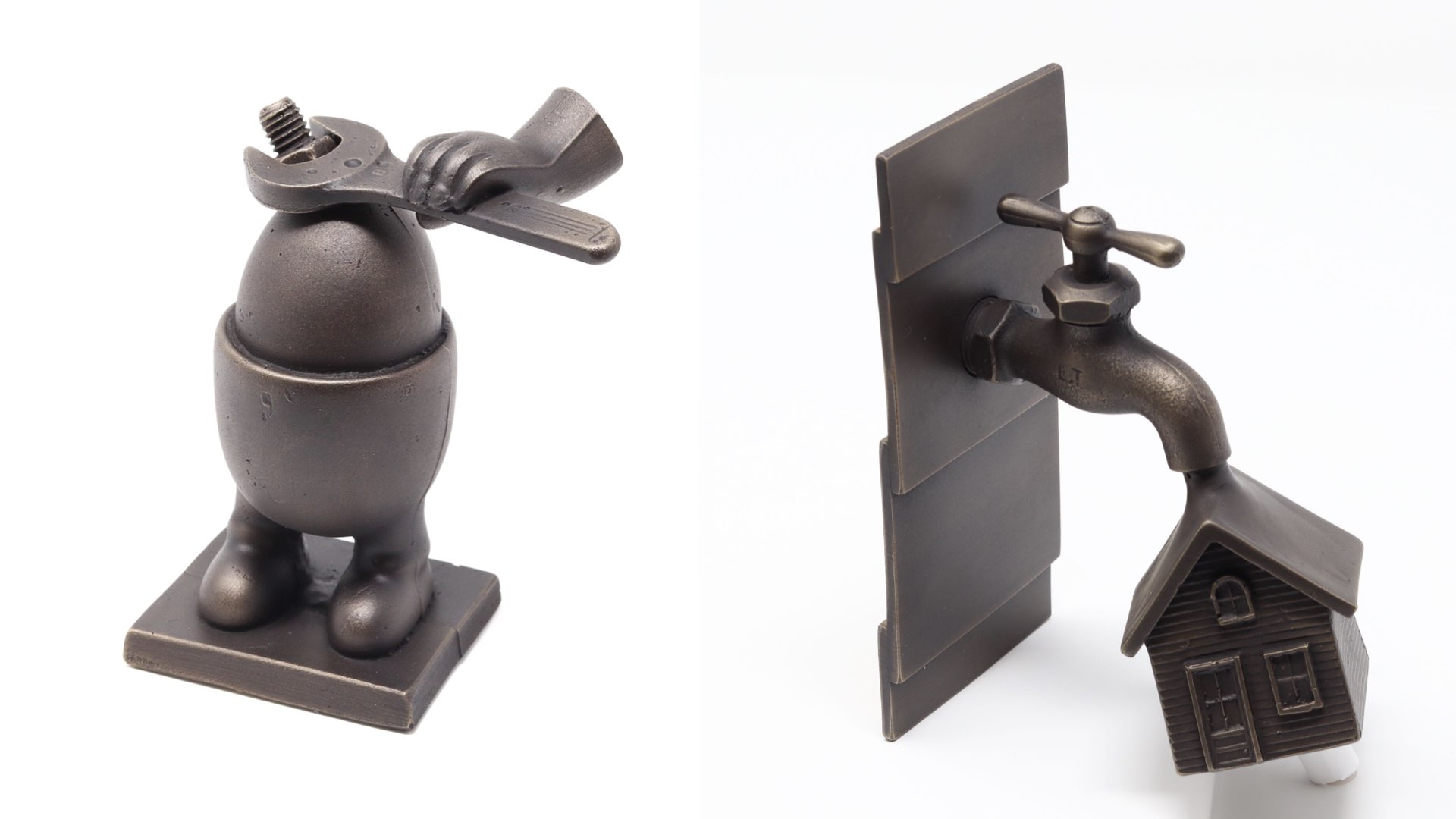 Two metal decorative objects: one shaped like a dog with a bow, the other a faucet with a house-shaped spout.