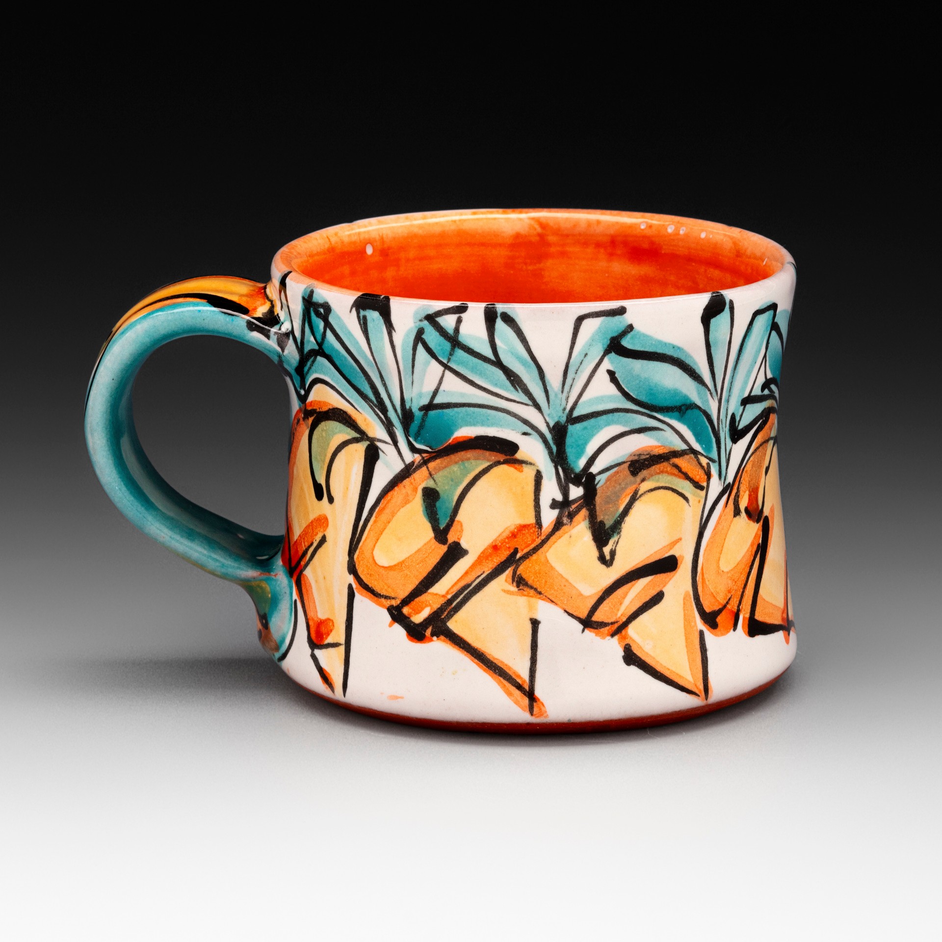 Colorful ceramic mug with abstract orange, blue, and black patterns on a gray background.