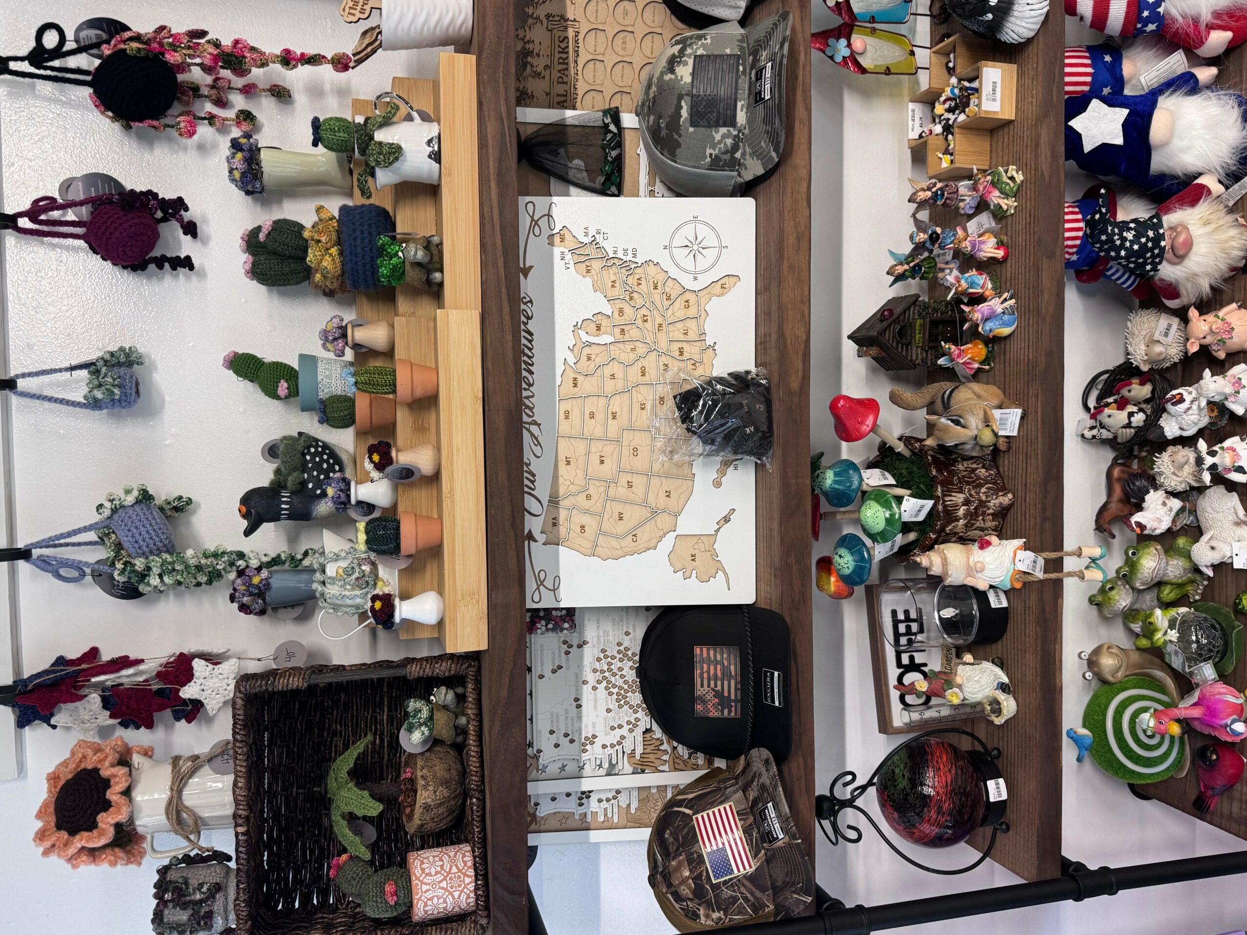 Shelves with various decorative items, toys, and ornaments arranged on a wall, including stuffed animals, figurines, and craft supplies.