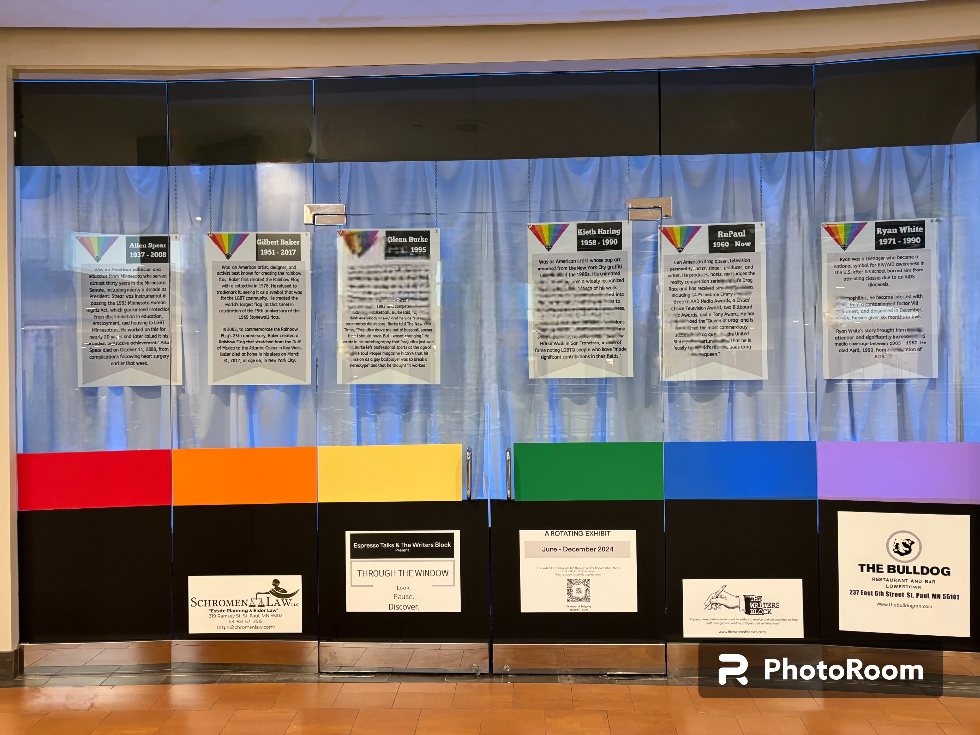 Display with multiple informational posters and colorful panels, set against a blue curtain background.