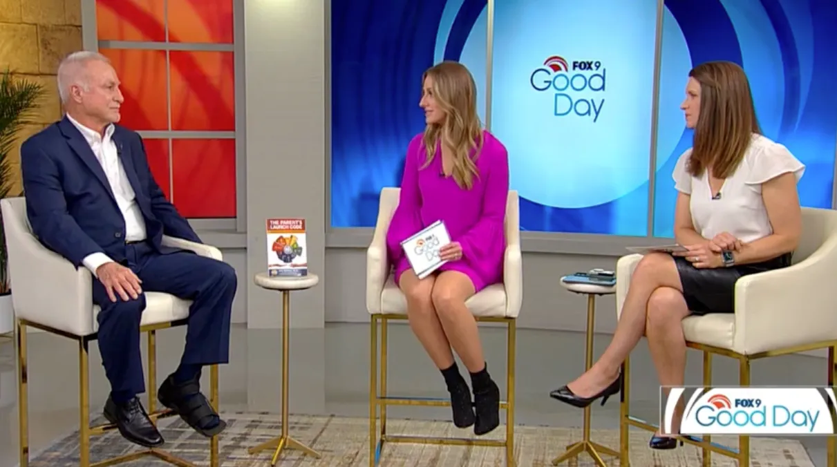 Three people seated in a TV studio, two women and one man, with a 'Good Day' logo in the background.