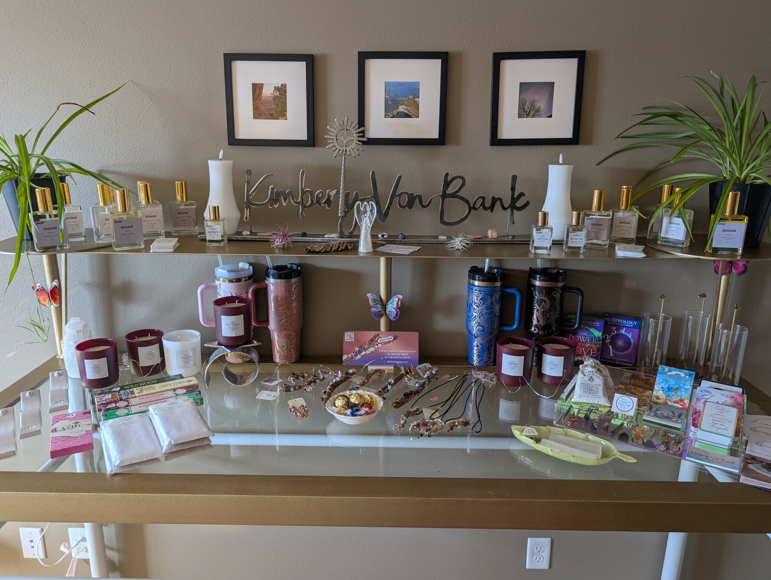 Display table with jars, snacks, and decorations, framed pictures on wall, plants, and a sign reading 'Thank You' in cursive.