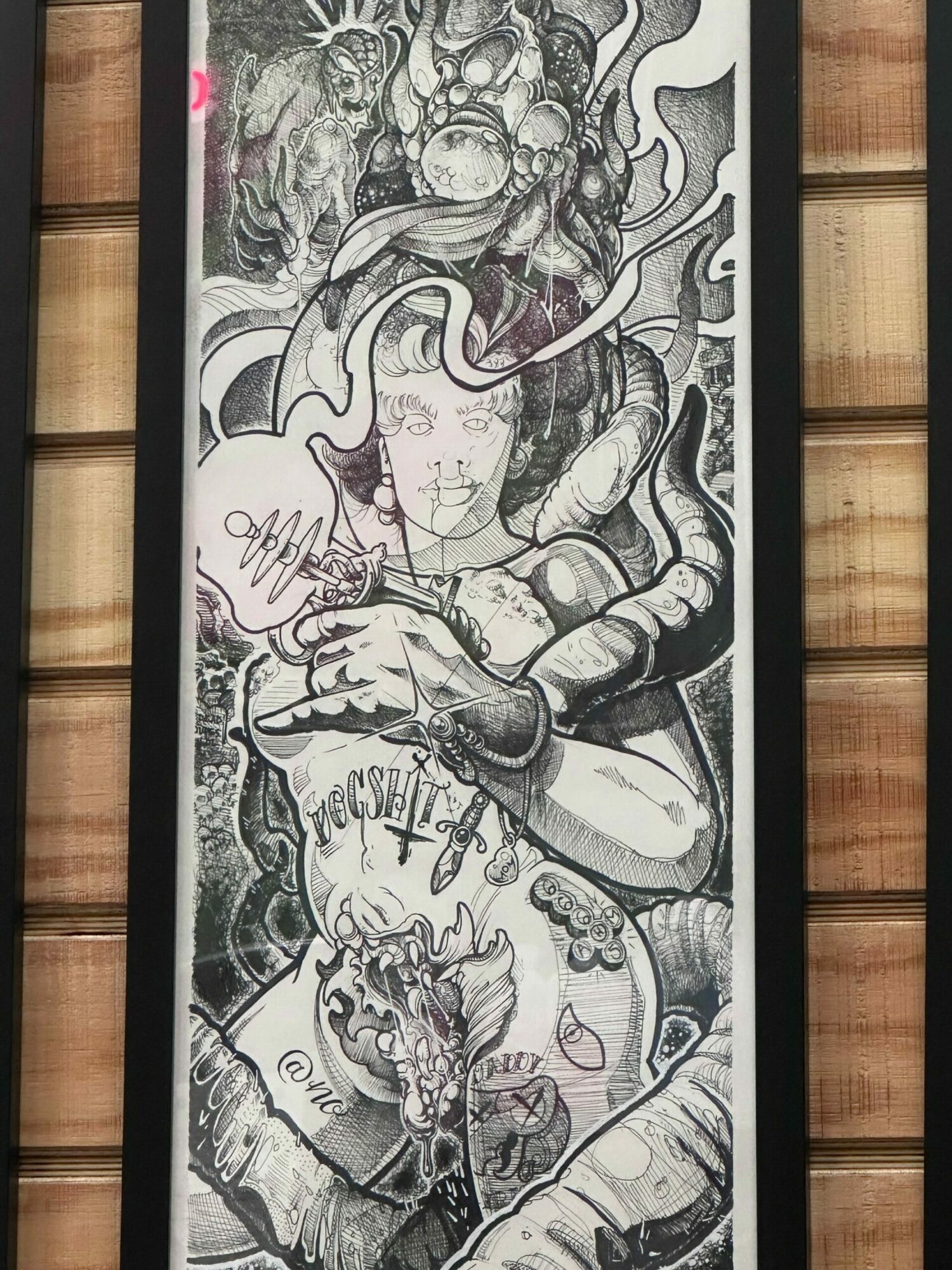 Black and white mural of a woman with flowing hair, holding a child, with intricate details and patterns.