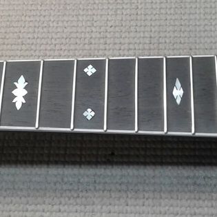 Close-up of a row of domino tiles with various symbols, on a textured surface.
