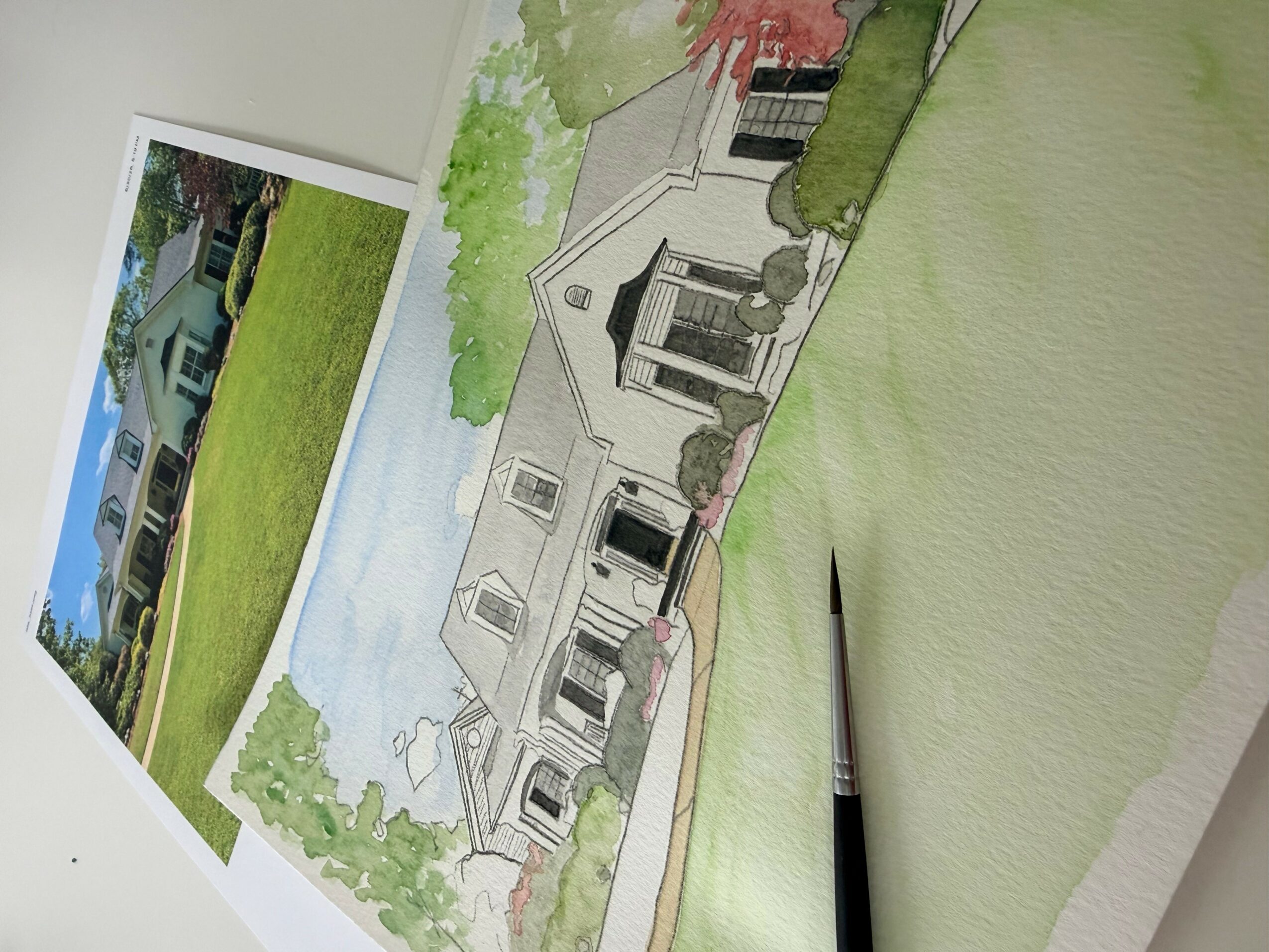 Architectural drawing of a house with trees and landscaping, next to a photograph of a house with a lawn and trees.