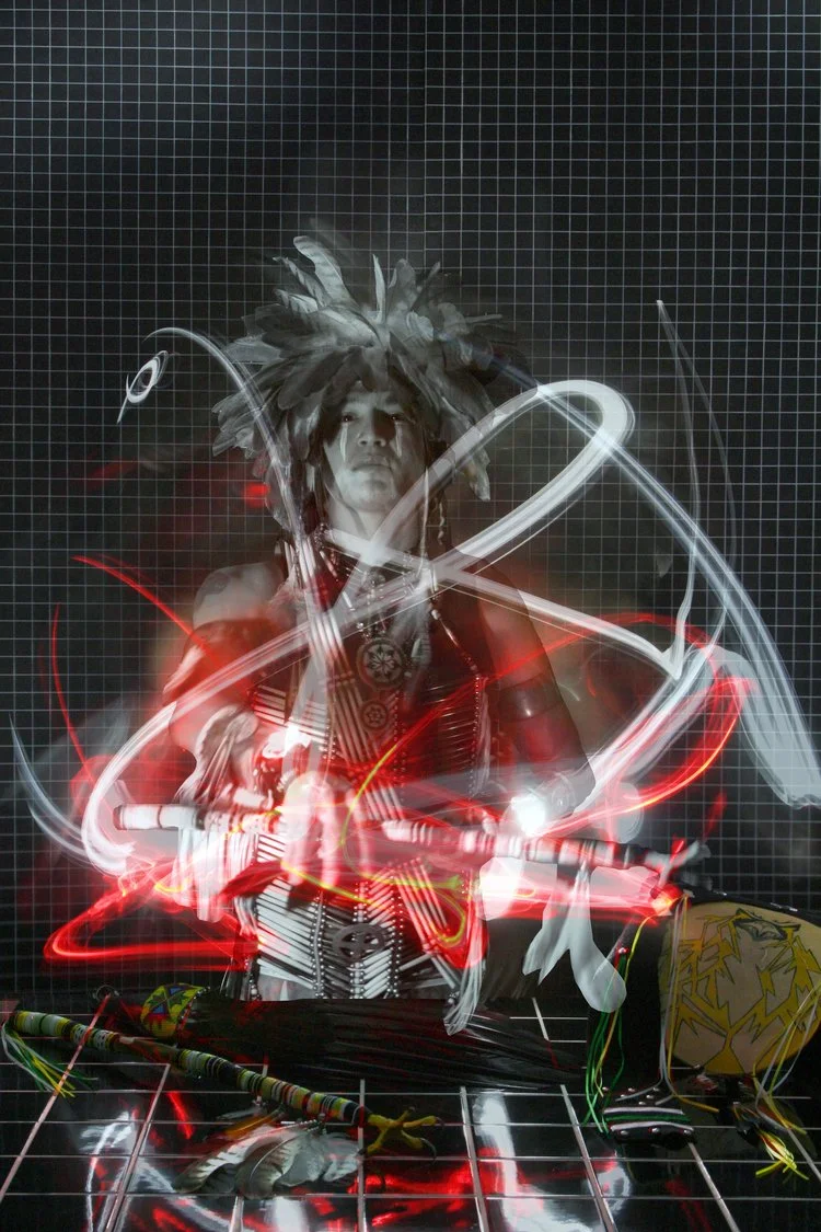 Person with wild hair and face paint, surrounded by light trails, standing in front of a grid background.