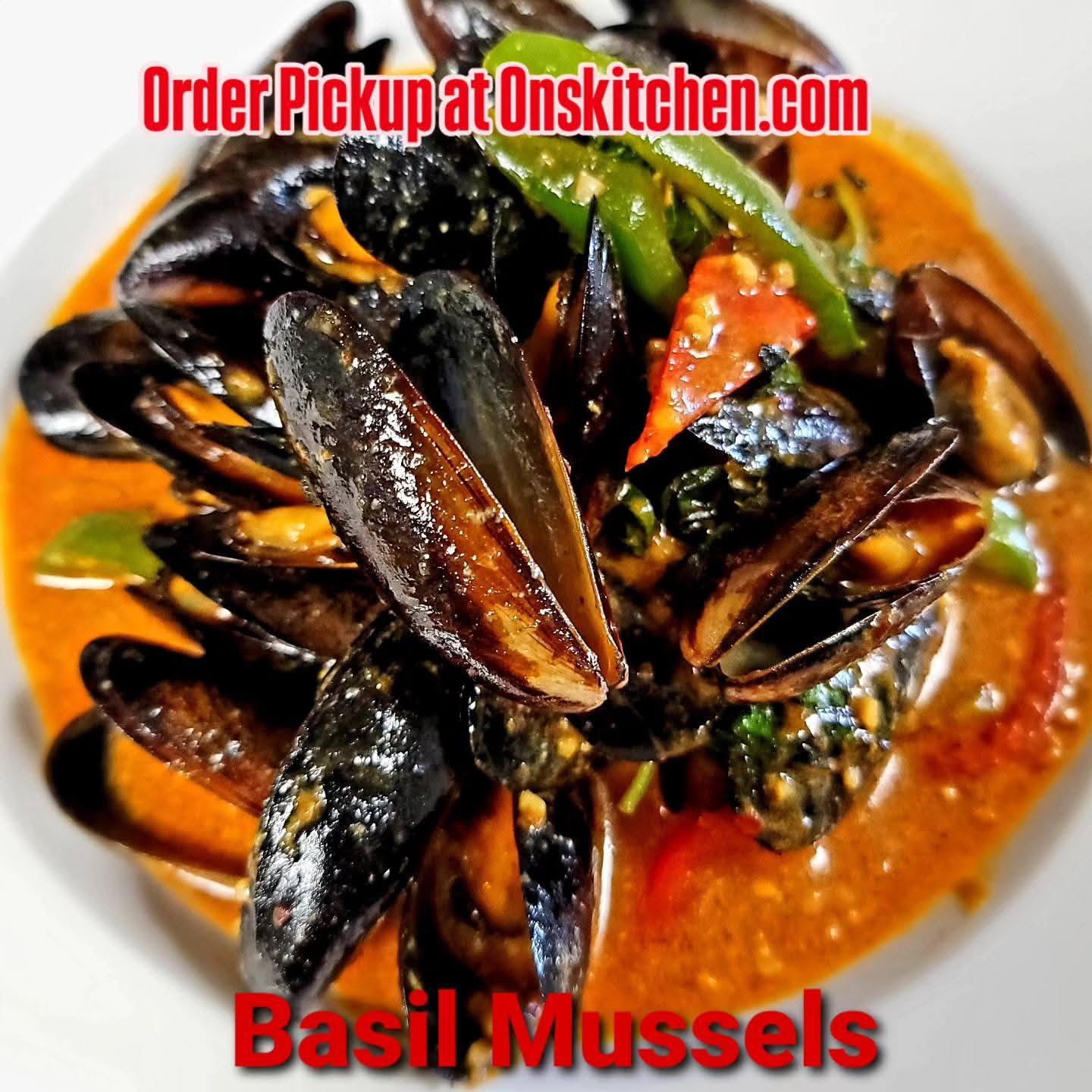Basil mussels in a spicy sauce with green and red vegetables, served in a white bowl.