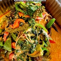 Colorful mixed vegetable salad with greens, peppers, and other vegetables in a bowl.