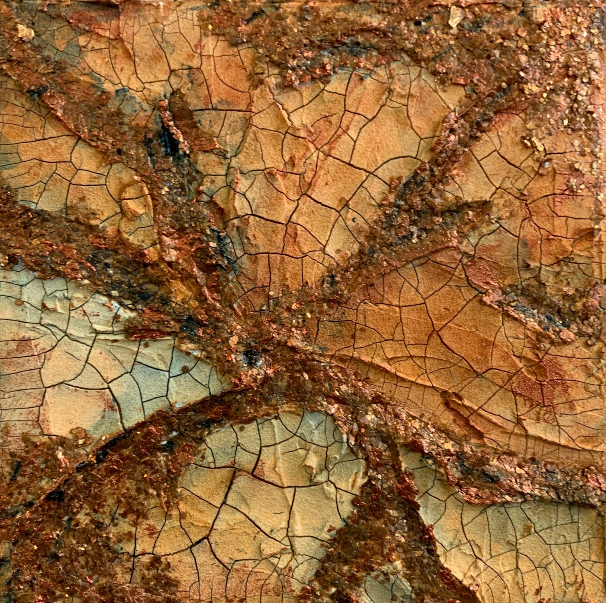 Close-up of a textured, cracked surface with reddish-brown and beige colors, and rough, raised areas.