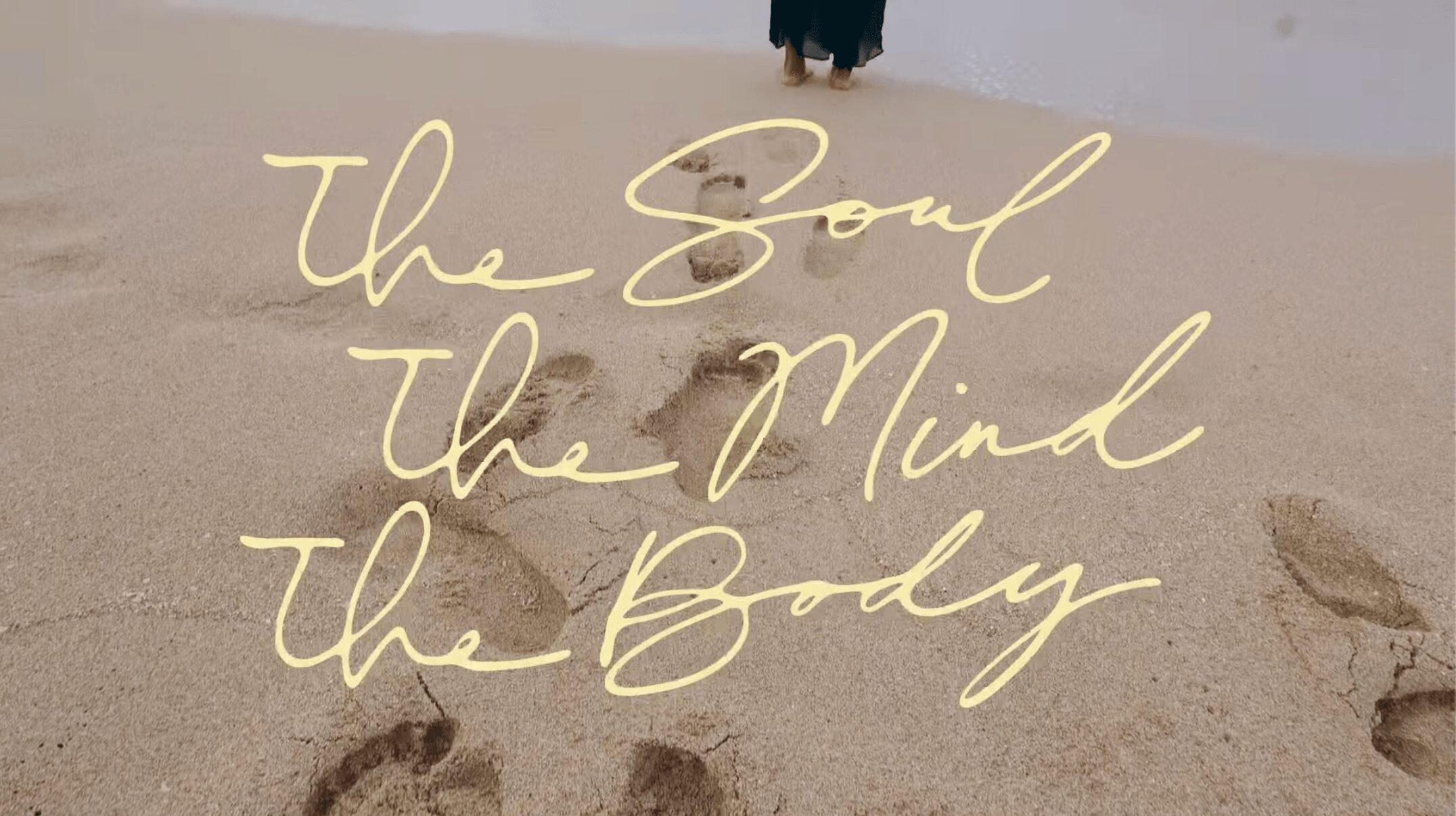 Footprints in sand with a person walking away, overlaid with the text 'the Soul the Mind the Body'.