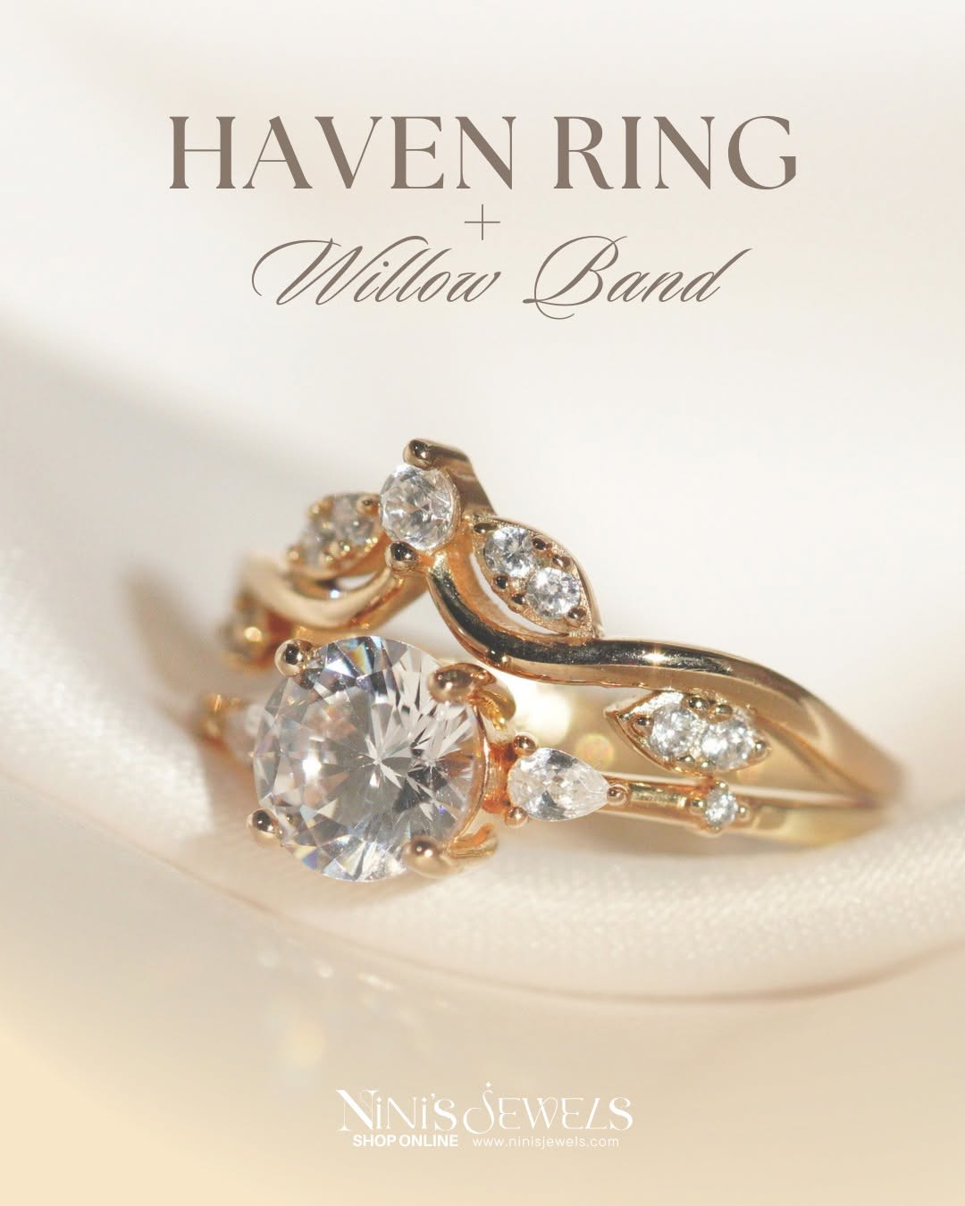 Close-up of a gold ring with a large central diamond and smaller diamonds, on a soft white surface.