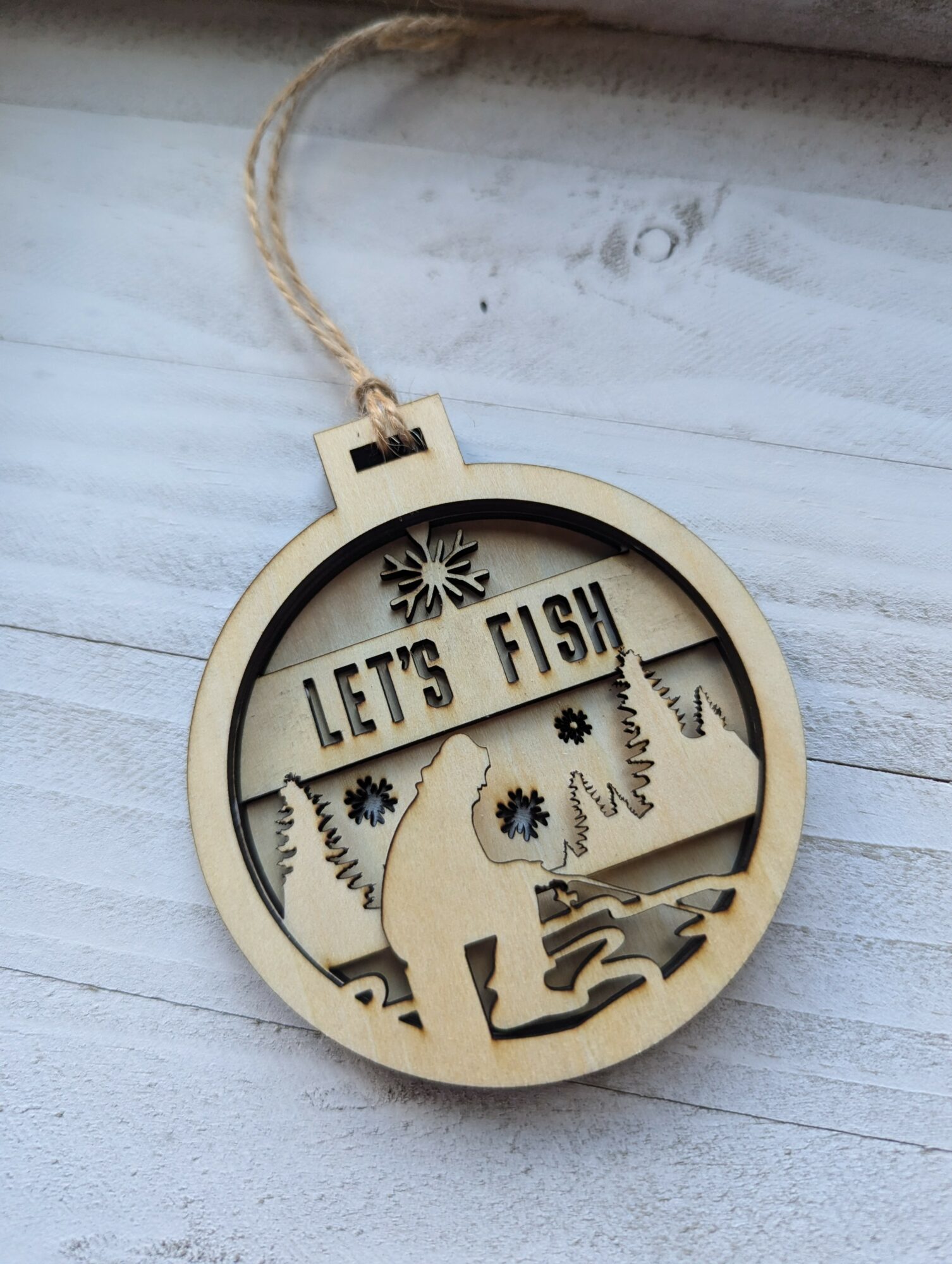 Wooden ornament with a cat silhouette, fish, and the text