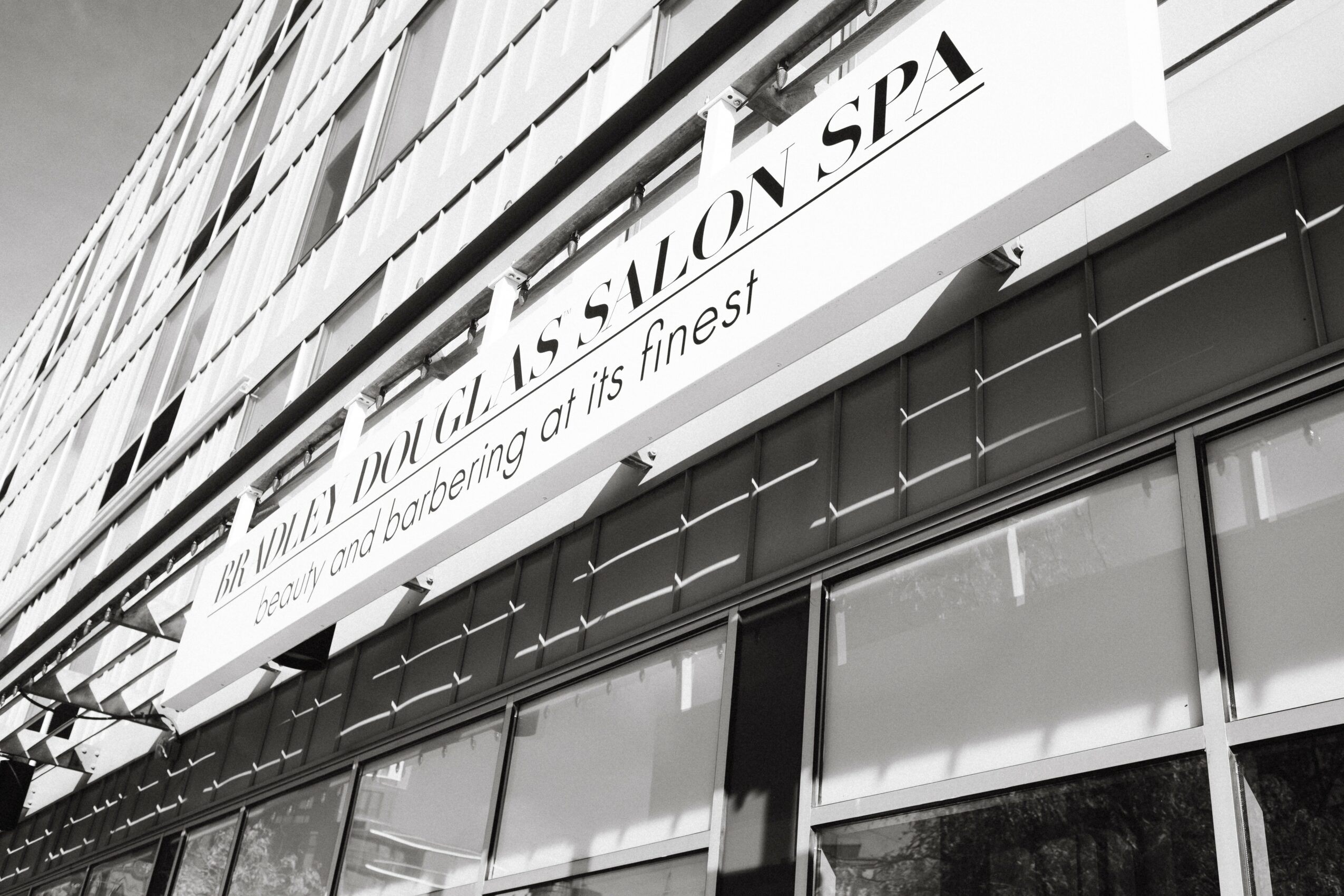 Building exterior with a sign reading 'Salon Spa' and large glass windows.