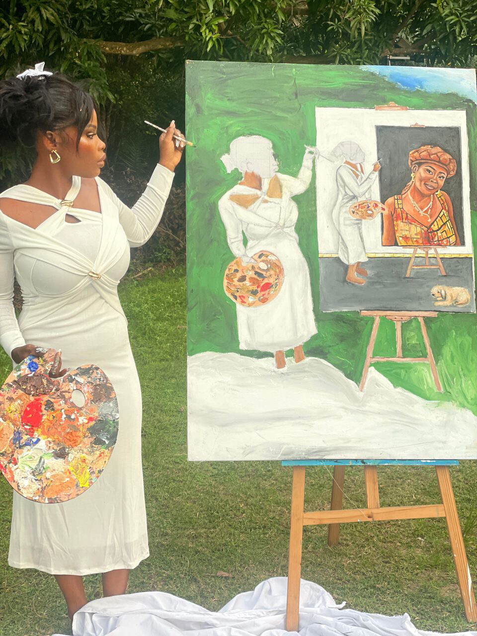 Woman in white dress painting outdoors on a large canvas, holding a palette, with trees in background.