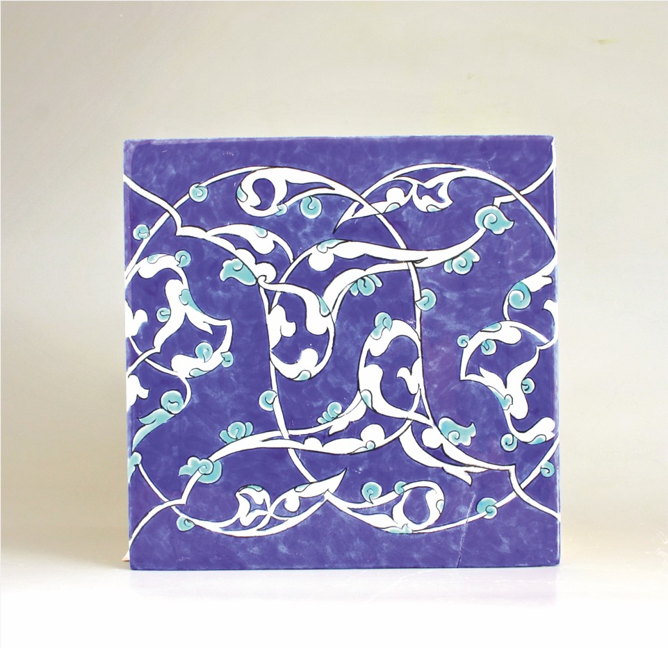 Decorative tile with white and light blue floral patterns on a purple background.