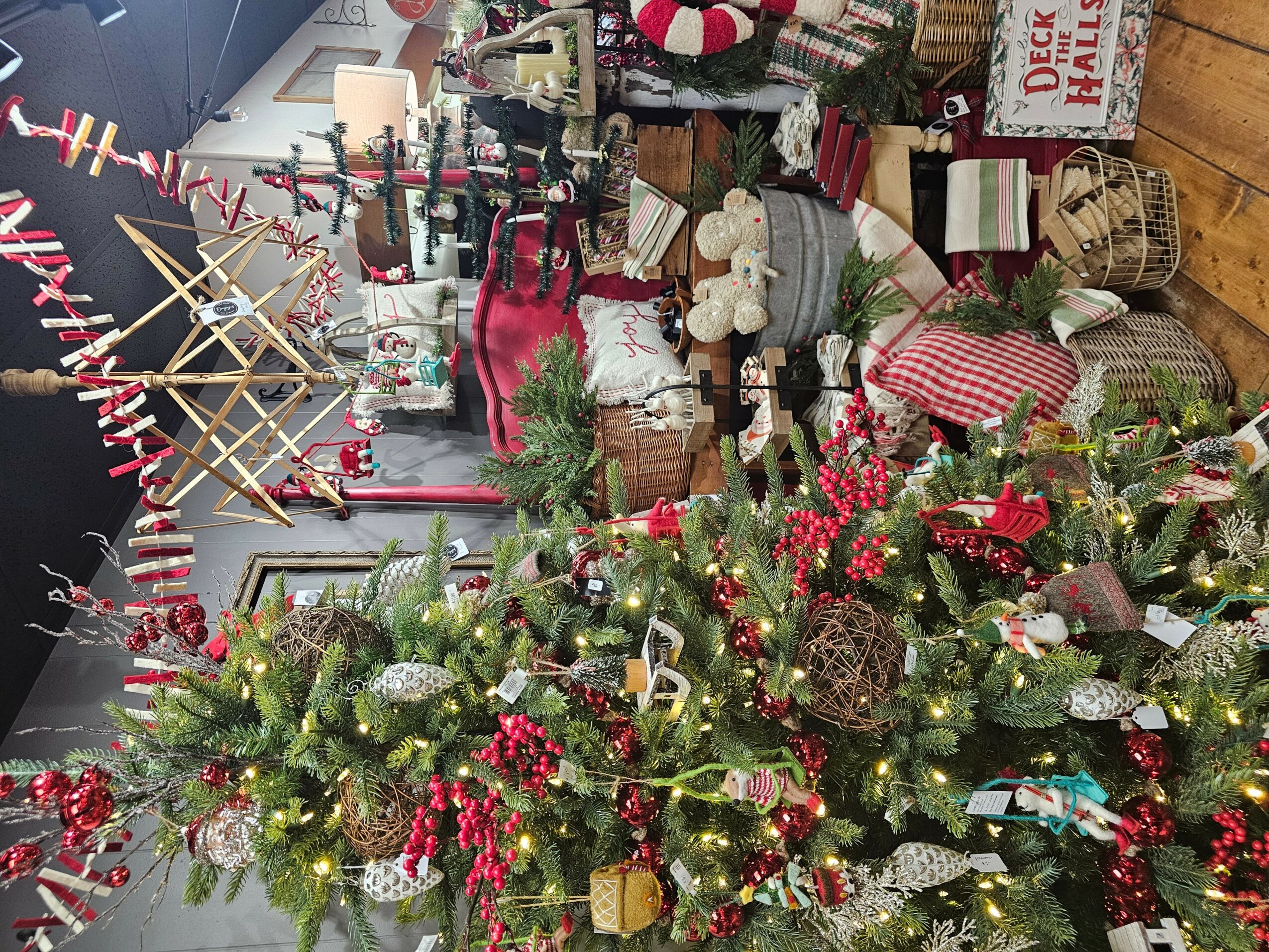 Christmas decorations including a decorated tree with red and gold ornaments, presents, and festive ornaments in a room.