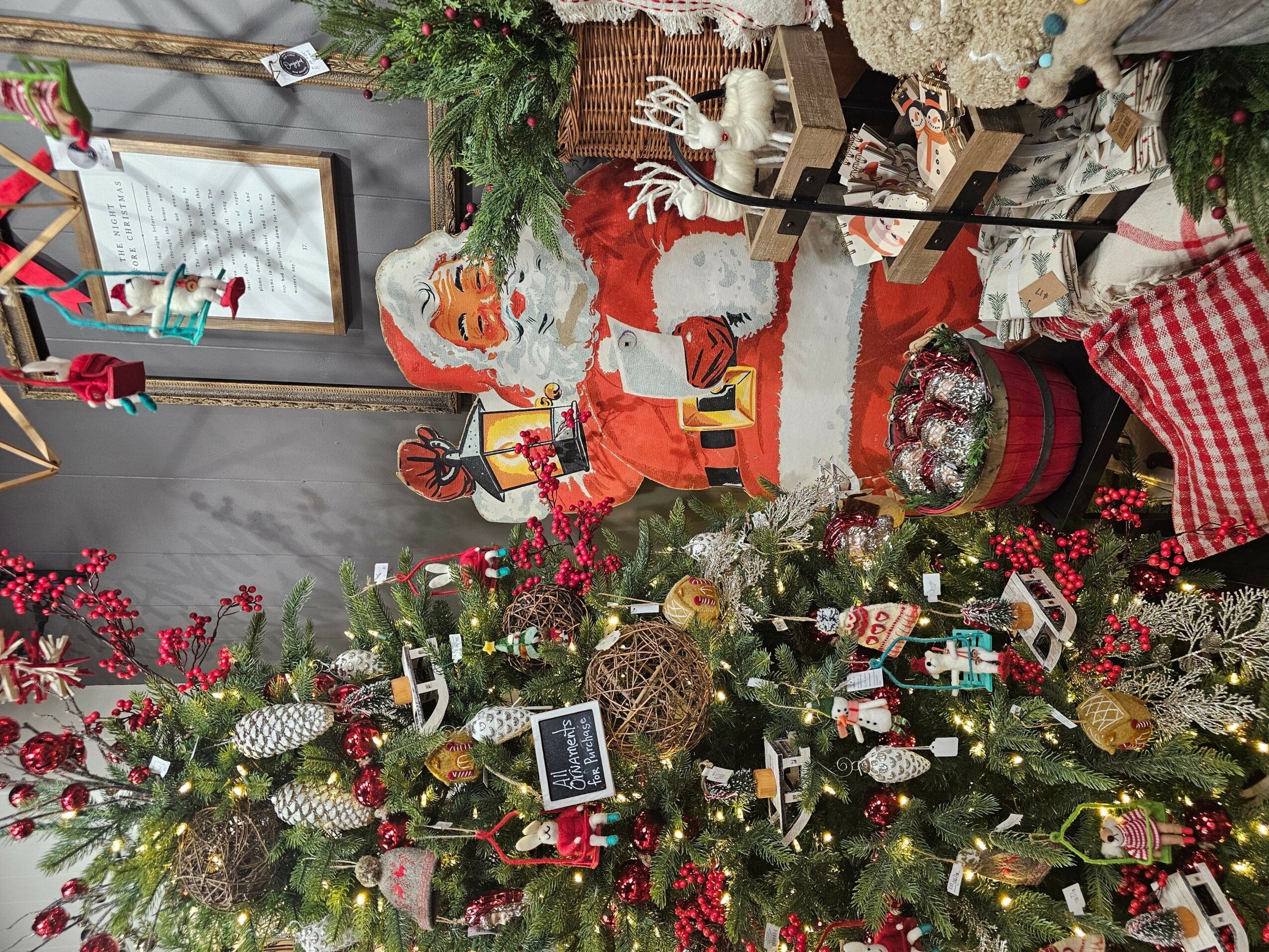 Christmas scene with Santa figure, decorated tree, and festive ornaments, including a snowman, presents, and holiday decorations.