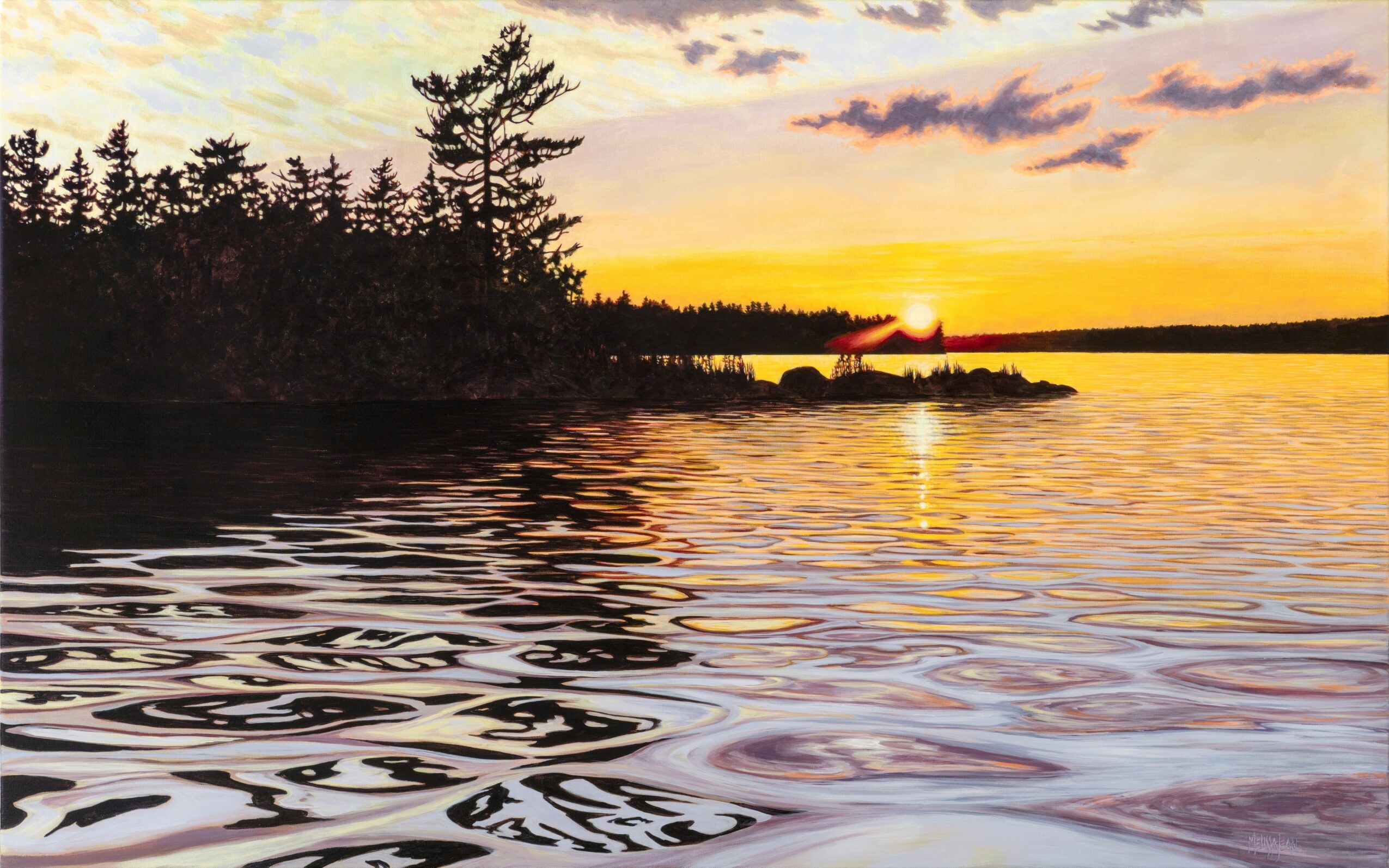 Sunset over a lake with trees on the left and rippling water in the foreground, sky with clouds and orange hues.