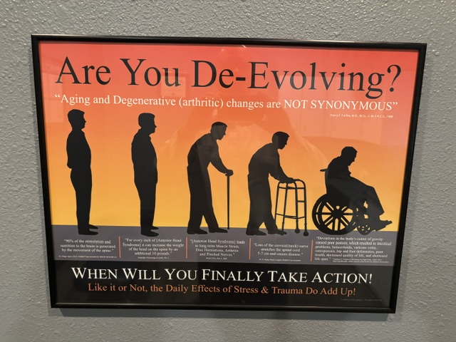Sign with silhouettes of a person aging and using a walker, ending in a person in a wheelchair, with text about aging and action.